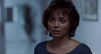 Movie still from “Love & Basketball” (2000), directed by Gina Prince-Bythewood – A person with short brown hair; Close Up shot, Over the shoulder angle