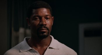 Movie still from “Love & Basketball” (2000), directed by Gina Prince-Bythewood – A person wearing a white shirt; Close Up shot, Low angle