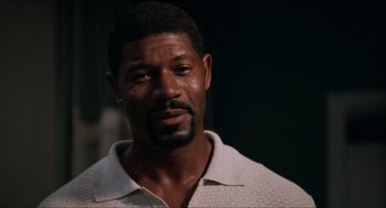 Movie still from “Love & Basketball” (2000), directed by Gina Prince-Bythewood – A person wearing a white shirt; Close Up shot, Low angle