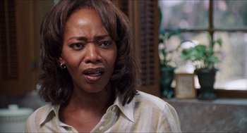 Movie still from “Love & Basketball” (2000), directed by Gina Prince-Bythewood – A person wearing a striped shirt; Close Up shot, Over the shoulder angle