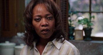 Movie still from “Love & Basketball” (2000), directed by Gina Prince-Bythewood – A person wearing a striped shirt; Close Up shot, Over the shoulder angle