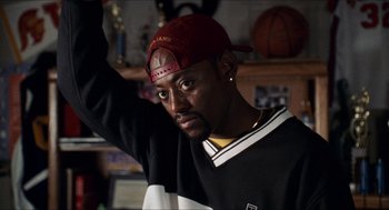 Movie still from “Love & Basketball” (2000), directed by Gina Prince-Bythewood – A person wearing a hat; Close Up shot, High angle