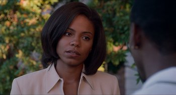 Movie still from “Love & Basketball” (2000), directed by Gina Prince-Bythewood – A woman that is wearing a jacket; Close Up shot, Over the shoulder angle