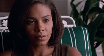 Movie still from “Love & Basketball” (2000), directed by Gina Prince-Bythewood – A person sitting in a chair; Close Up shot, Over the shoulder angle