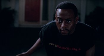 Movie still from “Love & Basketball” (2000), directed by Gina Prince-Bythewood – A person wearing a black shirt; Close Up shot, Low angle