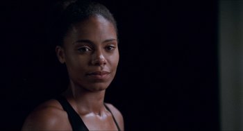 Movie still from “Love & Basketball” (2000), directed by Gina Prince-Bythewood – A person wearing a black shirt; Close Up shot, Low angle