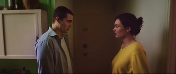 Movie still from “Love” (2015), directed by Gaspar Noé – A man and a woman standing next to each other in a room; Medium shot, Low angle