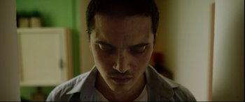 Movie still from “Love” (2015), directed by Gaspar Noé – A person looking at the camera; Close Up shot, Low angle