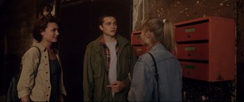 Movie still from “Love” (2015), directed by Gaspar Noé – A man and a woman standing next to each other; Medium shot, Over the shoulder angle