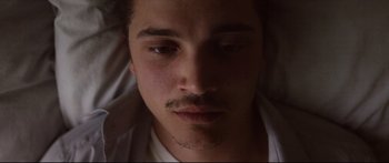 Movie still from “Love” (2015), directed by Gaspar Noé – A person with a mustache; Close Up shot, Overhead angle