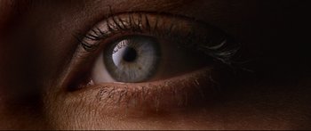 Movie still from “Love” (2015), directed by Gaspar Noé – A person's blue eye with long lashes; Extreme Close Up shot, Overhead angle