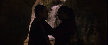 Movie still from “Love” (2015), directed by Gaspar Noé – A man and a woman are standing in front of a waterfall; Medium shot, Low angle