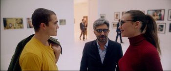 Movie still from “Love” (2015), directed by Gaspar Noé – A group of people standing in an art gallery; Medium shot, Over the shoulder angle