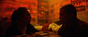 Movie still from “Love” (2015), directed by Gaspar Noé – A man and a woman sitting at a coffee table; Medium shot, Over the shoulder angle