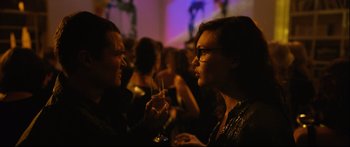 Movie still from “Love” (2015), directed by Gaspar Noé – A man and a woman sitting at a table with drinks; Close Up shot, Over the shoulder angle