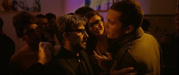 Movie still from “Love” (2015), directed by Gaspar Noé – A group of people that are standing around each other; Close Up shot, Over the shoulder angle