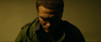 Movie still from “Love” (2015), directed by Gaspar Noé – A young man is looking down at his face; Close Up shot, High angle
