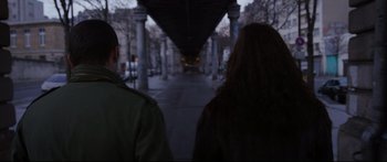 Movie still from “Love” (2015), directed by Gaspar Noé – A man and a woman walking down a sidewalk; Medium shot, Over the shoulder angle