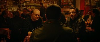 Movie still from “Love” (2015), directed by Gaspar Noé – A group of people sitting around a table; Medium shot, Over the shoulder angle