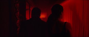 Movie still from “Love” (2015), directed by Gaspar Noé – Two people are silhouetted against a red light; Close Up shot, Low angle
