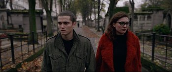 Movie still from “Love” (2015), directed by Gaspar Noé – A man and a woman walking down a street; Medium shot, High angle