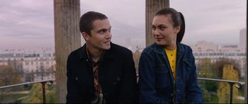 Movie still from “Love” (2015), directed by Gaspar Noé – A man and a woman sitting next to each other; Medium shot, Over the shoulder angle