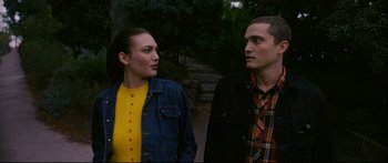 Movie still from “Love” (2015), directed by Gaspar Noé – A man and a woman standing next to each other; Medium shot, Over the shoulder angle