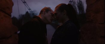 Movie still from “Love” (2015), directed by Gaspar Noé – A man and a woman face to face in the dark; Medium shot, High angle