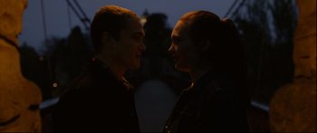 Movie still from “Love” (2015), directed by Gaspar Noé – Two men are facing each other in the dark; Medium shot, Over the shoulder angle