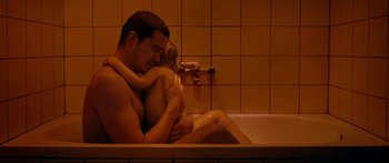 Movie still from “Love” (2015), directed by Gaspar Noé – A man and a little girl sitting in a bath tub; Medium shot, High angle