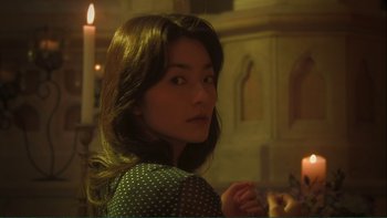 Movie still from “Love Exposure” (2008), directed by Sion Sono – A woman with long brown hair and a polka dot dress; Close Up shot, Low angle