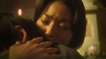 Movie still from “Love Exposure” (2008), directed by Sion Sono – A person holding a cell phone; Close Up shot, Low angle