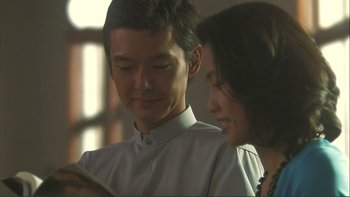 Movie still from “Love Exposure” (2008), directed by Sion Sono – A man and a woman looking at something on a tablet; Close Up shot, Over the shoulder angle