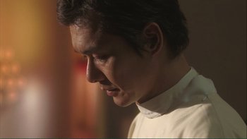 Movie still from “Love Exposure” (2008), directed by Sion Sono – A person wearing a white shirt; Close Up shot, Low angle