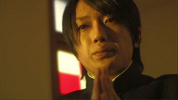 Movie still from “Love Exposure” (2008), directed by Sion Sono – A person with long black hair; Close Up shot, Low angle