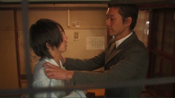 Movie still from “Love Exposure” (2008), directed by Sion Sono – A young man and a young woman are touching each other; Medium shot, Low angle