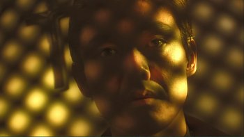 Movie still from “Love Exposure” (2008), directed by Sion Sono – A man's face in the light; Extreme Close Up shot, Low angle