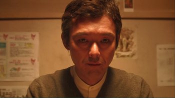 Movie still from “Love Exposure” (2008), directed by Sion Sono – A person wearing a sweater; Close Up shot, Low angle