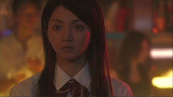 Movie still from “Love Exposure” (2008), directed by Sion Sono – A woman with long black hair wearing a red tie; Close Up shot, Low angle