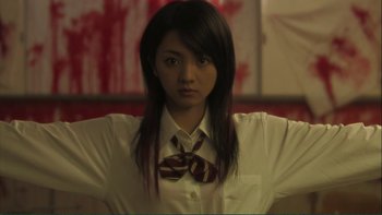 Movie still from “Love Exposure” (2008), directed by Sion Sono – A woman in a white shirt and a brown tie; Close Up shot, Low angle