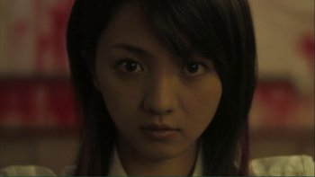 Movie still from “Love Exposure” (2008), directed by Sion Sono – A person with long black hair; Close Up shot, Low angle