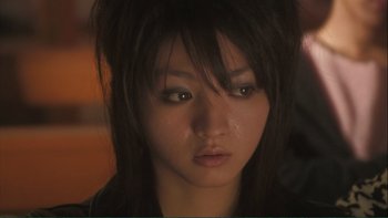 Movie still from “Love Exposure” (2008), directed by Sion Sono – A person with long black hair; Close Up shot, Low angle