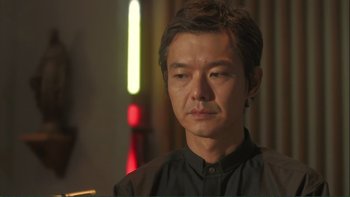 Movie still from “Love Exposure” (2008), directed by Sion Sono – A person wearing a black shirt; Close Up shot, Low angle