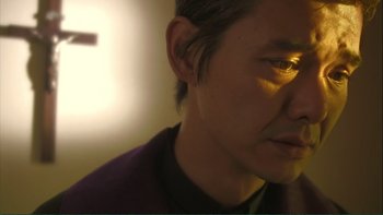 Movie still from “Love Exposure” (2008), directed by Sion Sono – A person's face with light shining on it; Close Up shot, Low angle