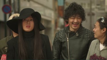 Movie still from “Love Exposure” (2008), directed by Sion Sono – A man and a woman walking down a street; Close Up shot, Low angle