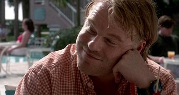 Movie still from “Love Liza” (2002), directed by Todd Louiso – A person wearing a red checkered shirt; Close Up shot, Over the shoulder angle
