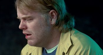 Movie still from “Love Liza” (2002), directed by Todd Louiso – A person wearing a yellow jacket; Close Up shot, Over the shoulder angle