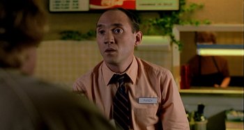 Movie still from “Love Liza” (2002), directed by Todd Louiso – A man in a pink shirt and a brown tie; Close Up shot, High angle