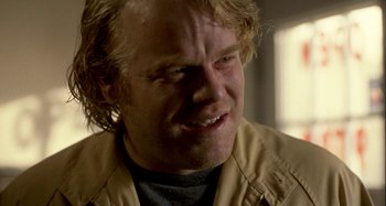 Movie still from “Love Liza” (2002), directed by Todd Louiso – A person wearing a shirt and jacket; Close Up shot, Over the shoulder angle