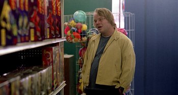 Movie still from “Love Liza” (2002), directed by Todd Louiso – A man standing in front of a display of toys; Medium shot, Over the shoulder angle